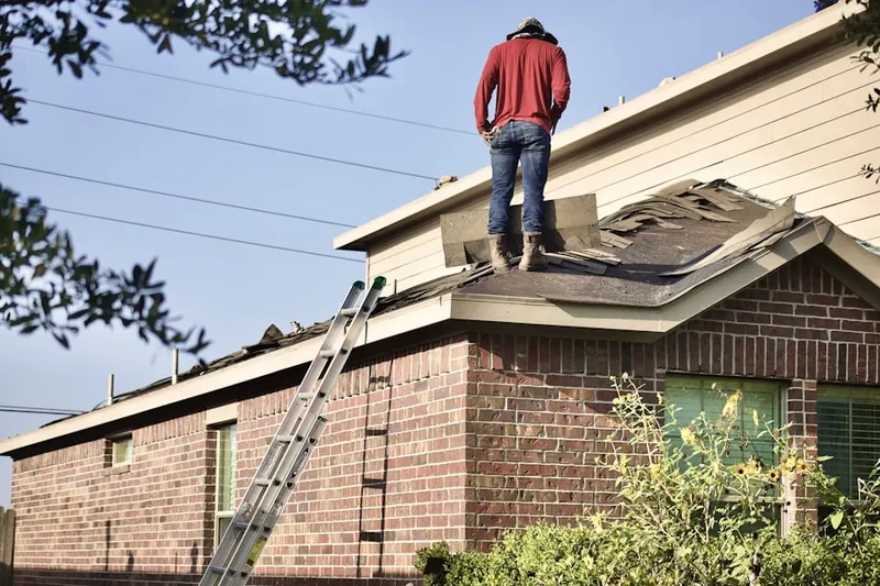 Professional roofer working on a residential roof in Coram